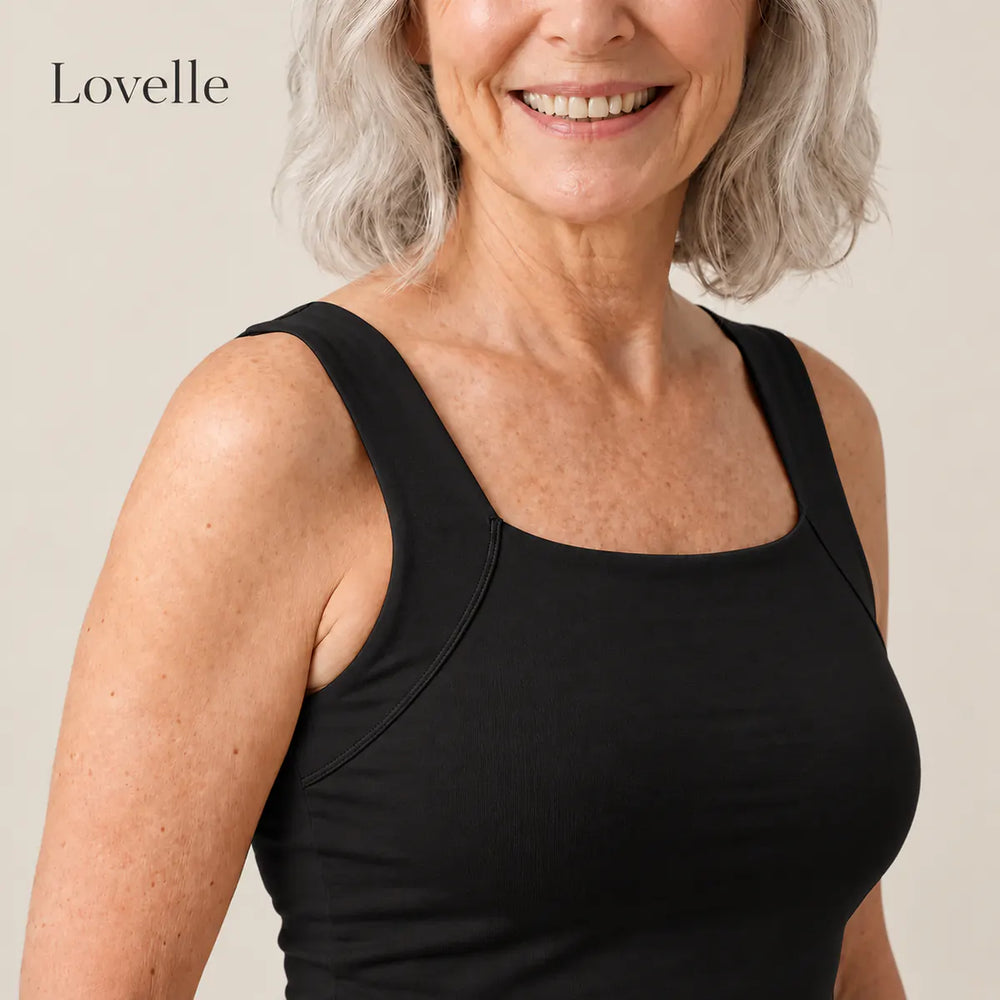 Smiling silver-haired woman wearing the Lovelle Ease built-in bra tank in black, square neckline and wide straps