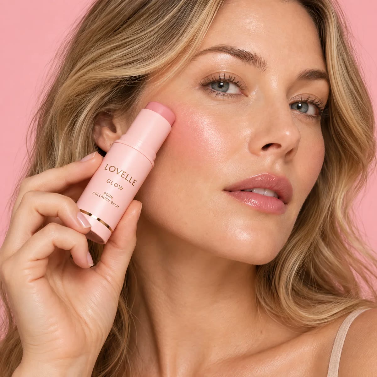 Woman applying Lovelle Glow to her cheek